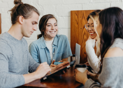 Diverse group of international students talking and supporting each other over coffee