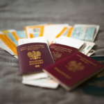 Passports and travel documents on a table representing visa duration of status rules