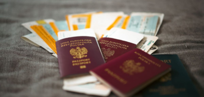Passports and travel documents on a table representing visa duration of status rules