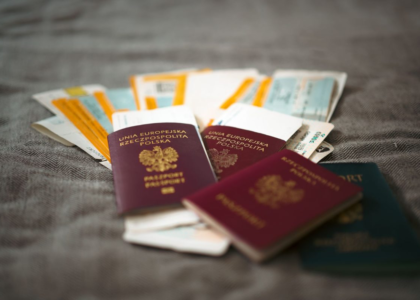 Passports and travel documents on a table representing visa duration of status rules