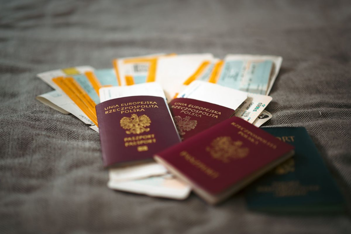 Passports and travel documents on a table representing visa duration of status rules