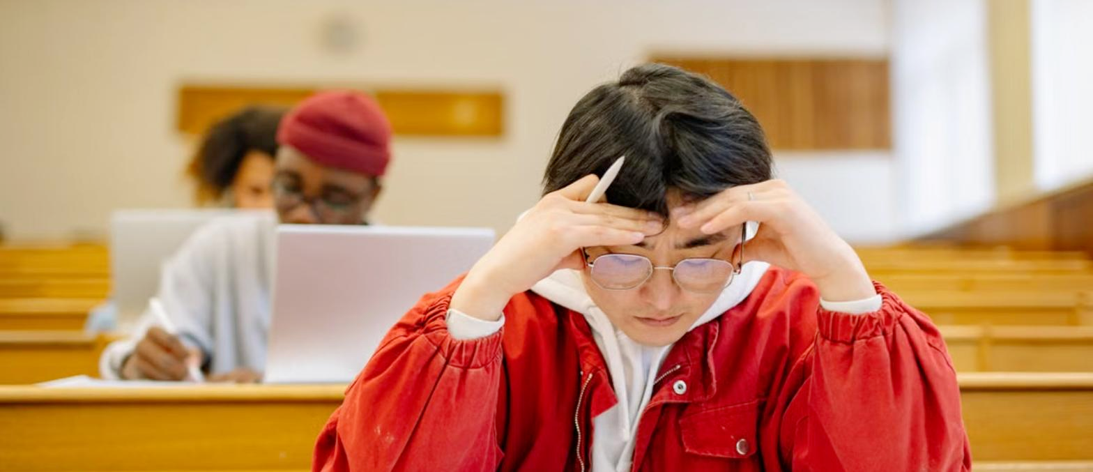 Indian student taking the dMAT exam in a university lecture hall