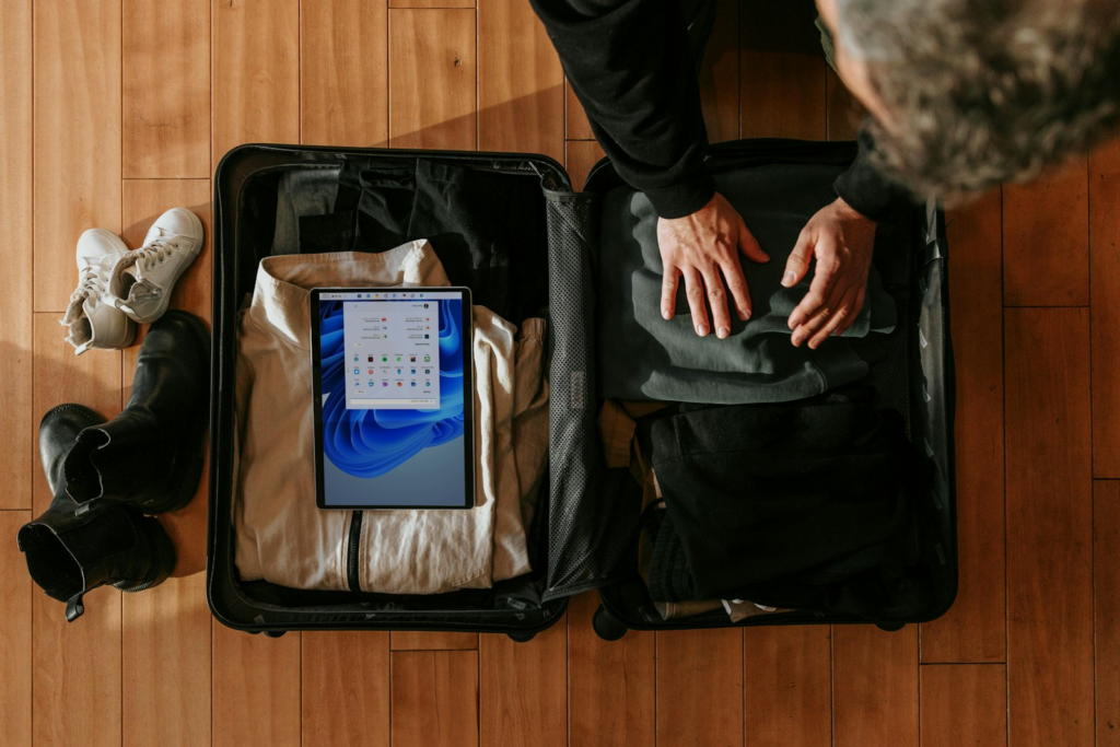 Overhead view of a student packing a suitcase for studying abroad