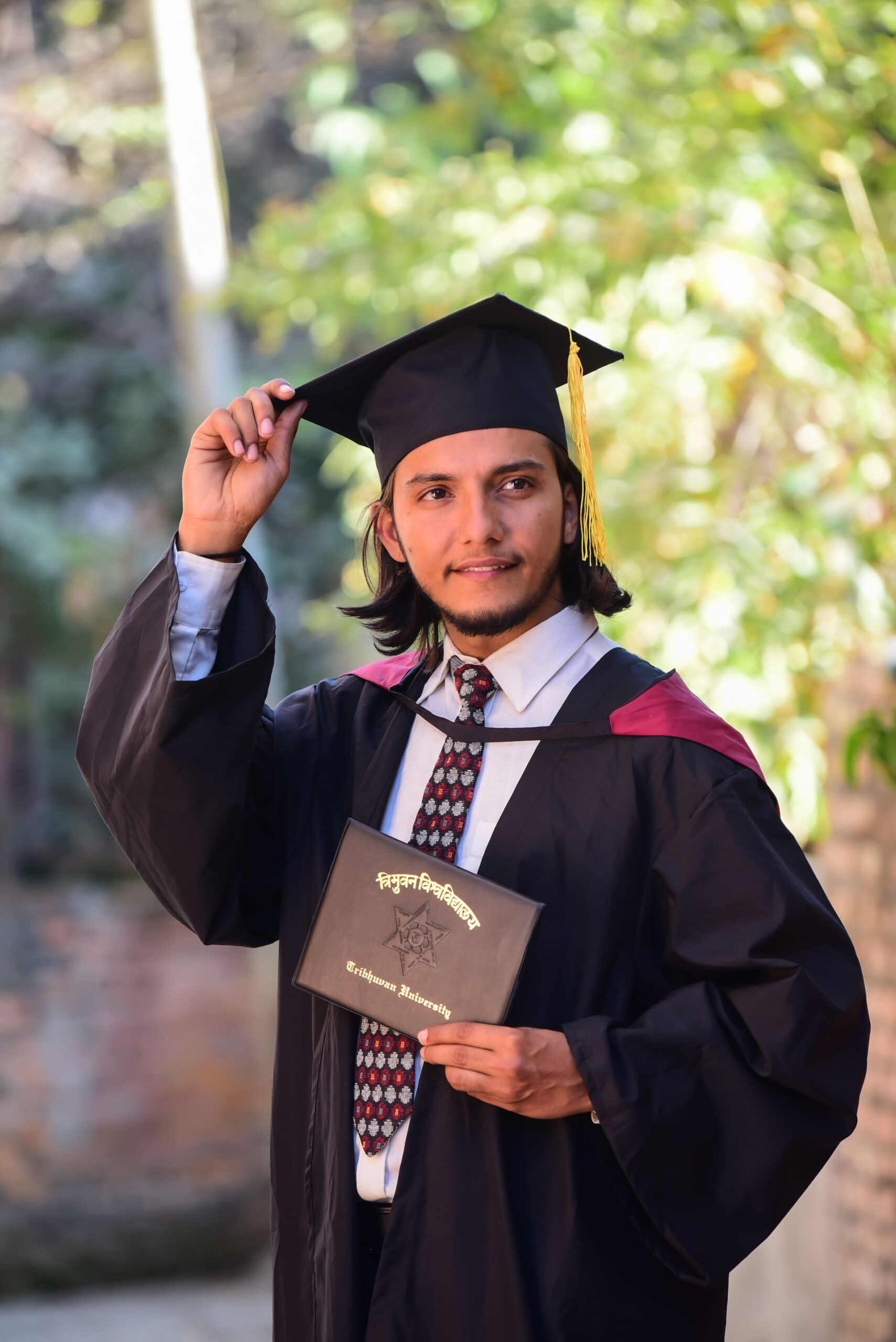 Graduate holding degree certificate representing successful study abroad outcome