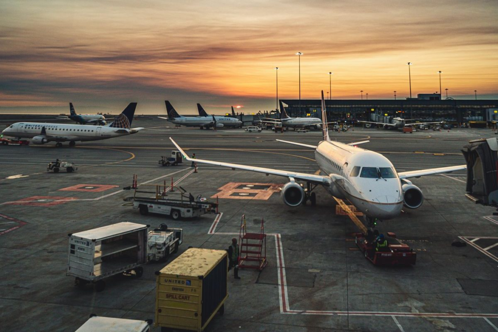 Airport terminal with aircraft representing travel disruption for Indian nationals in Australia