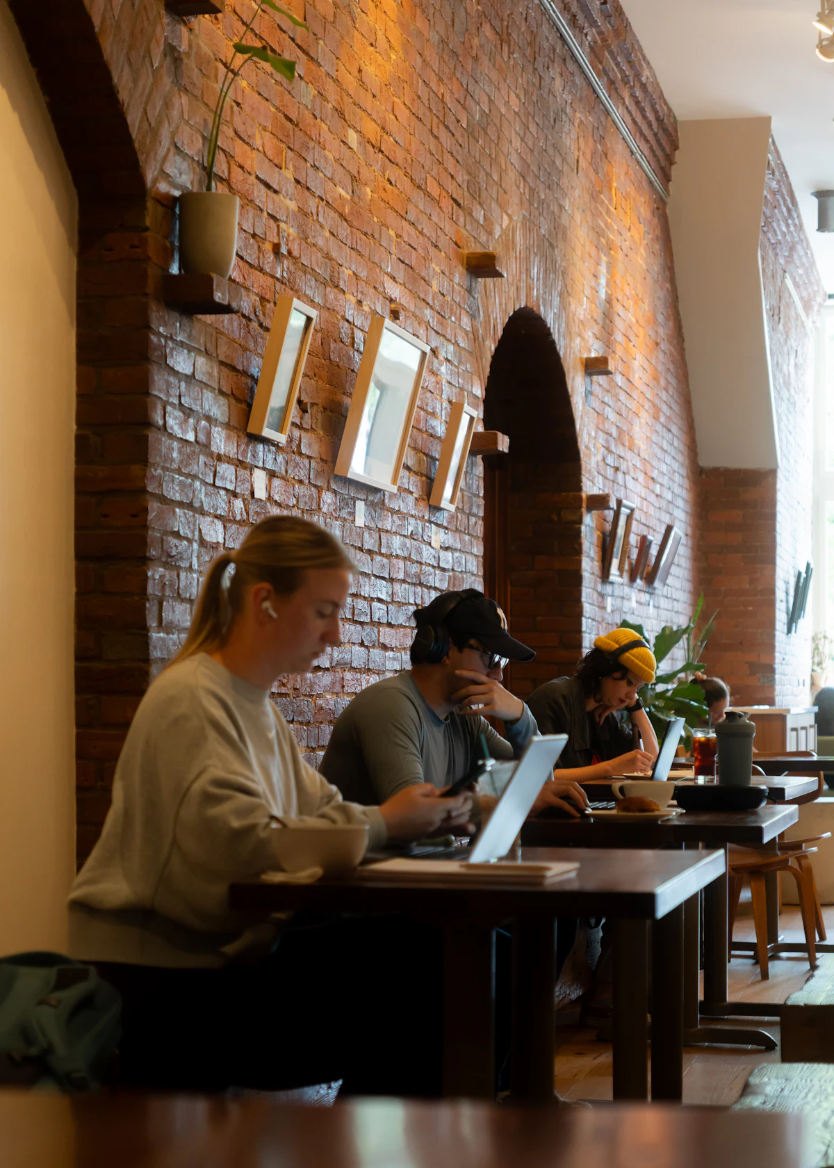 Students working on laptops in a cafe, showing part time work rights when you study in France 2026