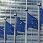 EU flags outside the European Commission in Brussels, where the EU AI Act international admissions rules were written