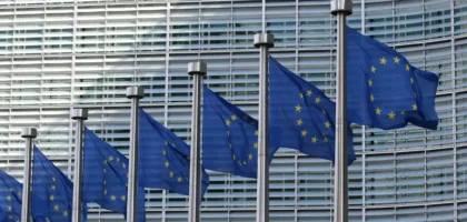 EU flags outside the European Commission in Brussels, where the EU AI Act international admissions rules were written
