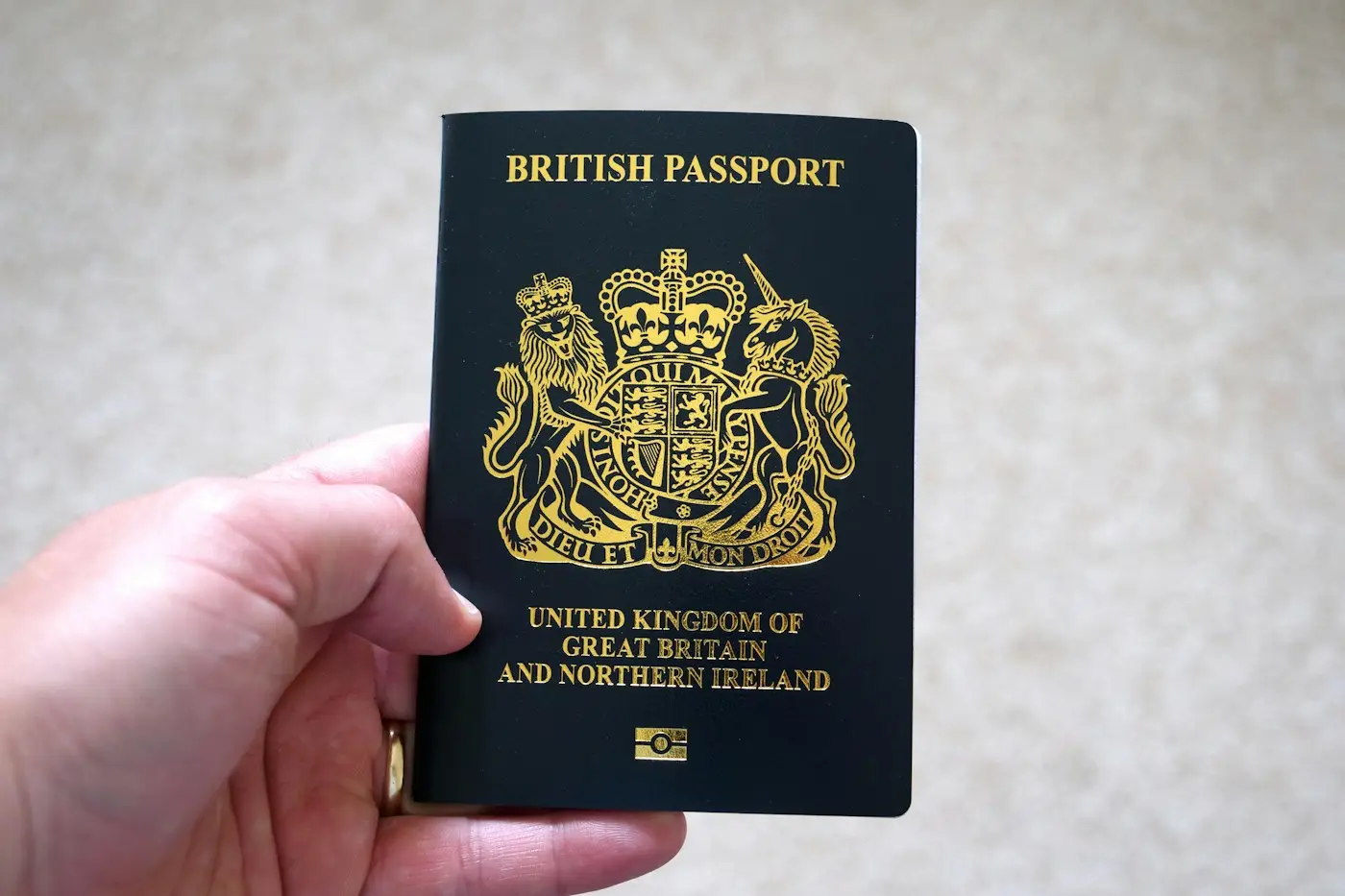 Hand holding a British passport, for the UK credibility interview section