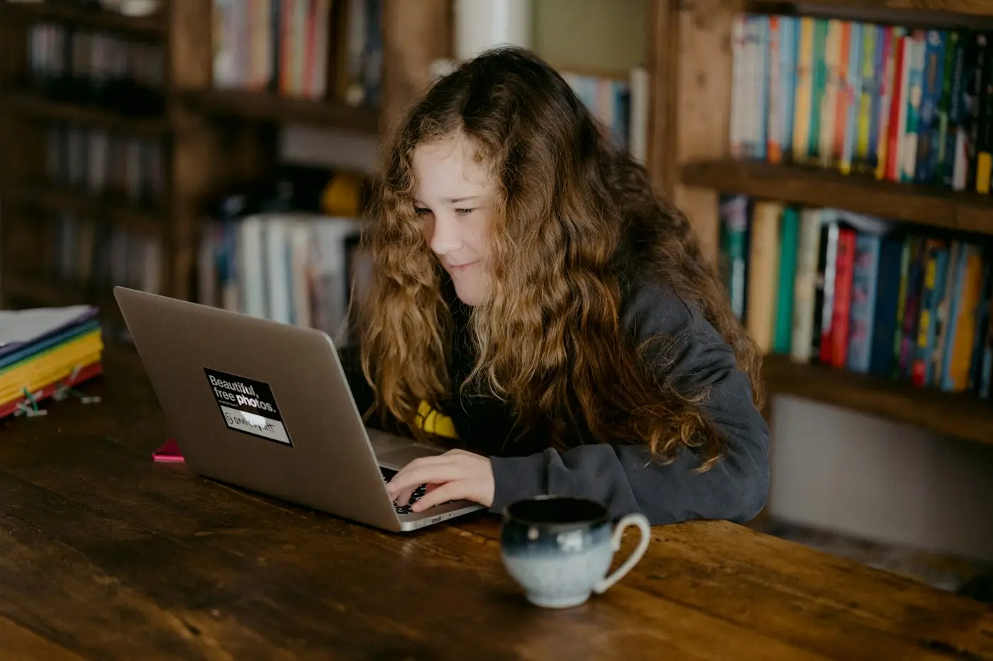 Student taking an online English test on a laptop at home