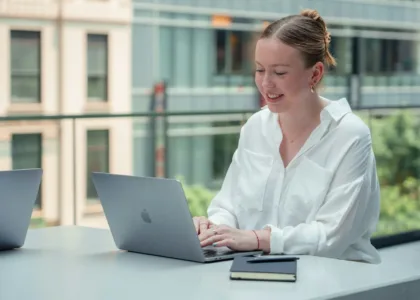 Student working at a laptop to shortlist universities abroad